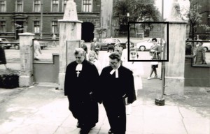 Uroczysty pochód konfirmantów wraz z księżmi do kościoła ewangelickiego. W czarnym prostokącie zaznaczyliśmy pomnik. Lata 70/80 XX wieku. Foto: Archiwum Parafii Ewangelickiej.